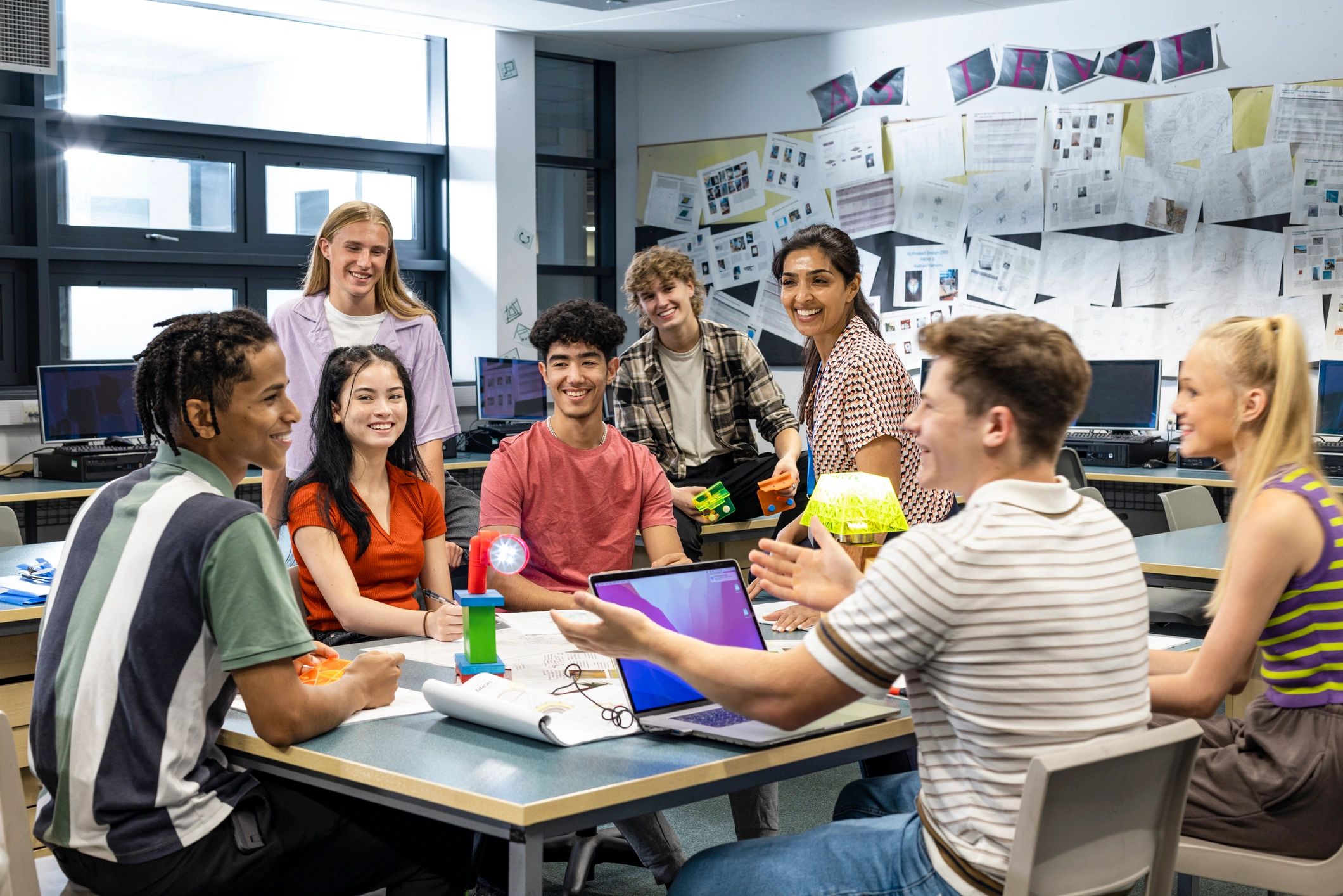 Students and teacher in a classroom using technology and networked devices