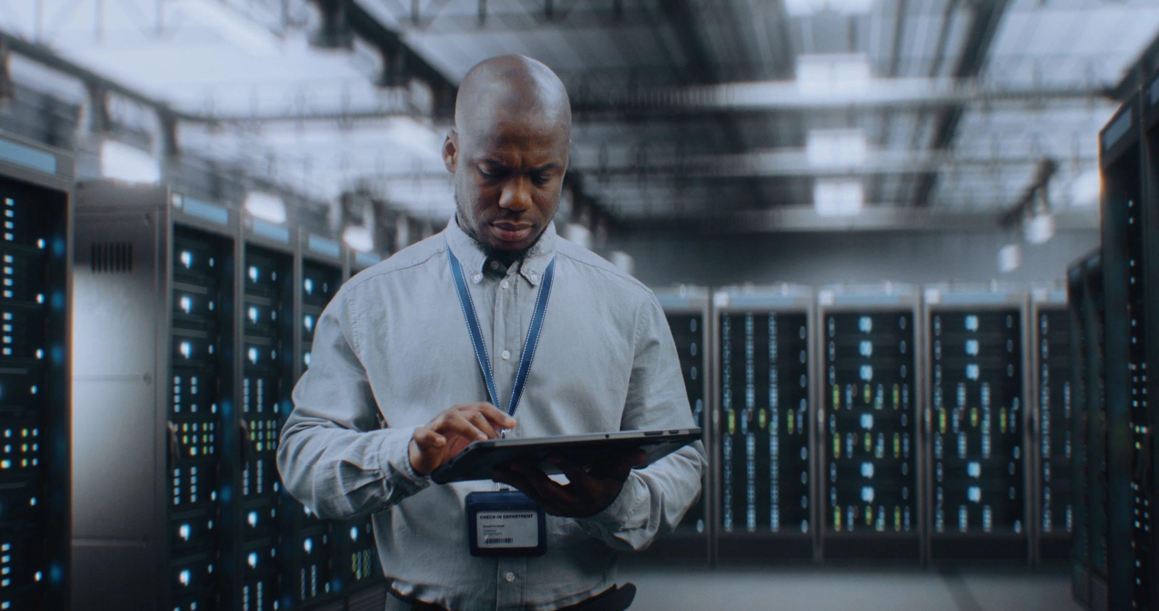 Technician working in a data center with server racks
